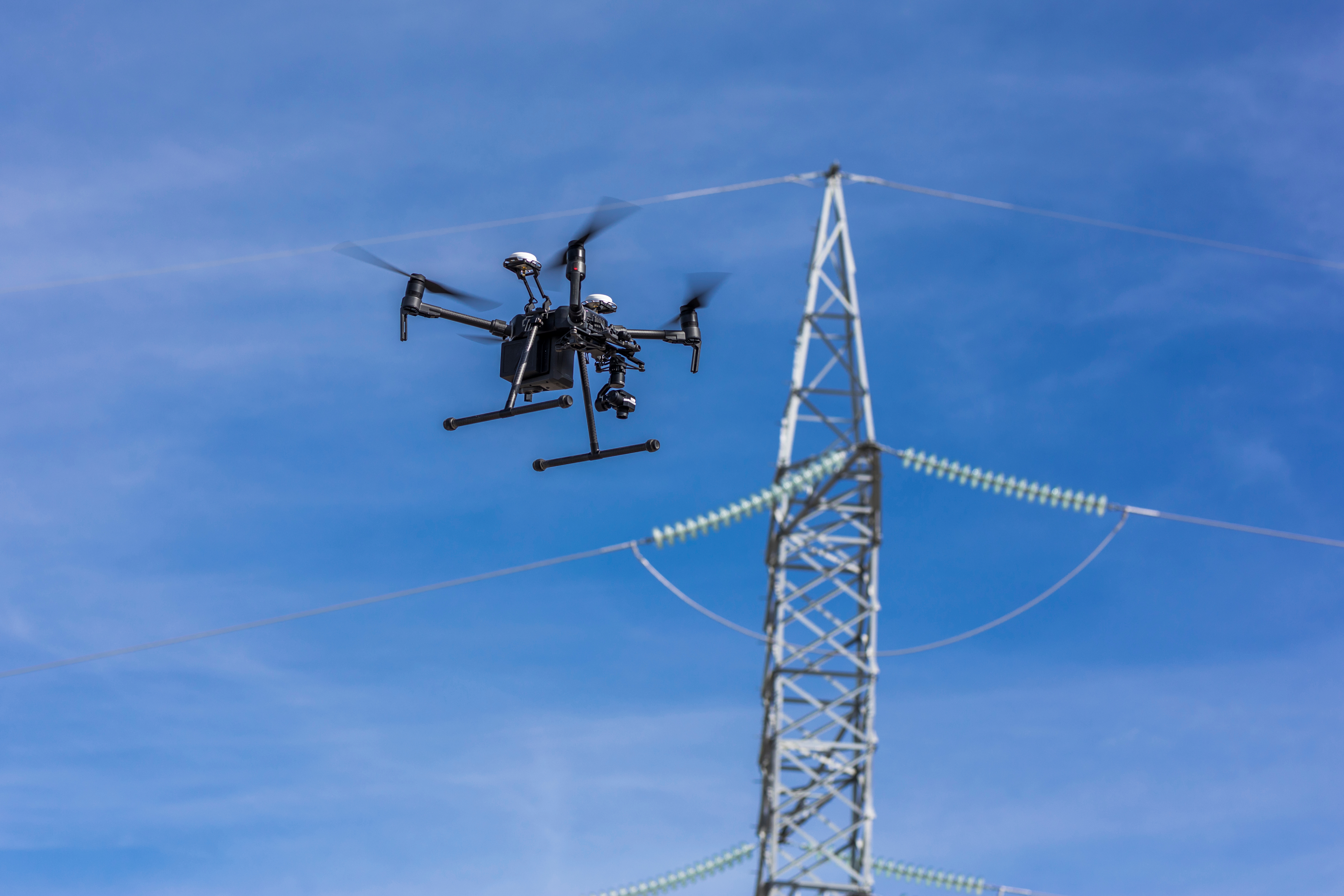 Image of a drone inspecting powerlines